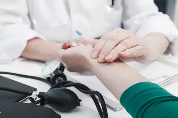 doctor-s-hand-tending-patient